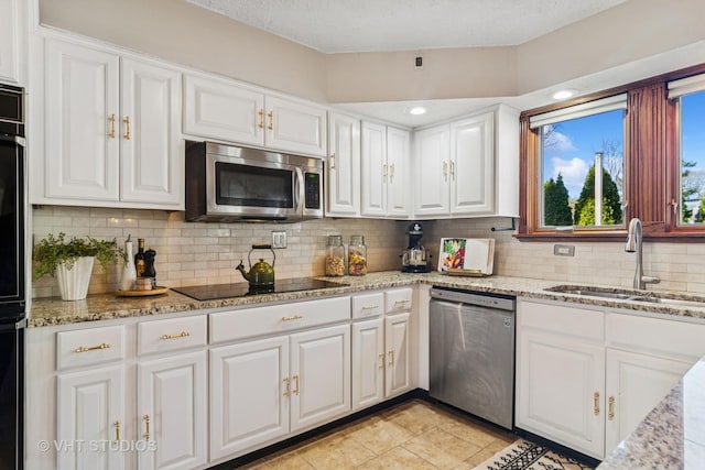 kitchen featuring white cabinetry, appliances with stainless steel finishes, and a sink