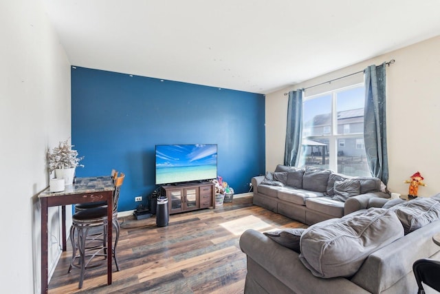 living room featuring baseboards and wood finished floors