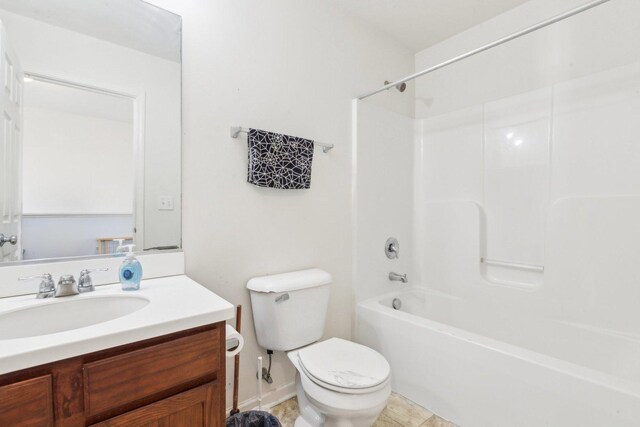 bathroom featuring washtub / shower combination, toilet, and vanity