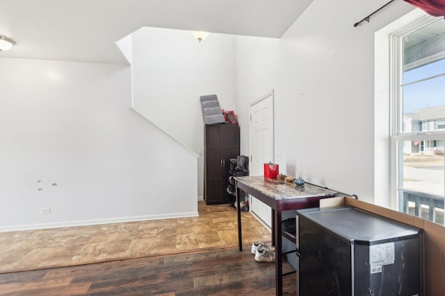 office area featuring baseboards and wood finished floors