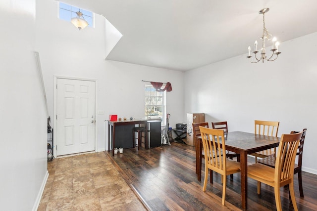 dining area with a notable chandelier, baseboards, and wood finished floors