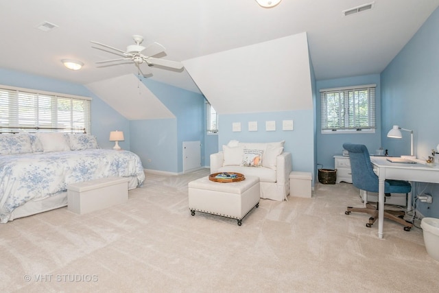 bedroom featuring light carpet, vaulted ceiling, visible vents, and multiple windows