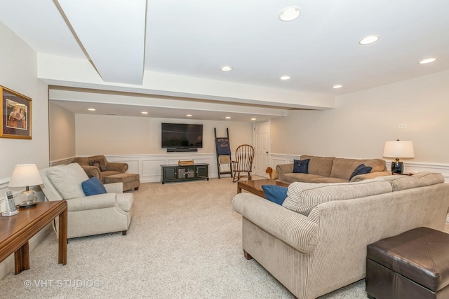 living area with recessed lighting, wainscoting, light carpet, and a decorative wall