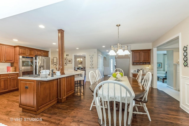 dining space with dark wood-style floors, recessed lighting, and a notable chandelier