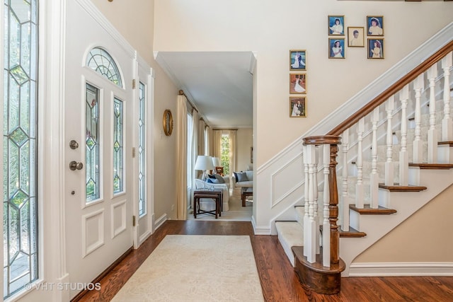 entryway featuring dark wood-type flooring and stairway