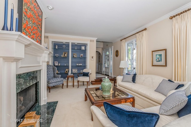 living room with a premium fireplace, carpet flooring, and crown molding