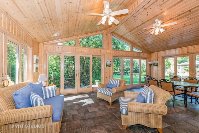 living area featuring wooden ceiling, wooden walls, stone finish floor, and french doors