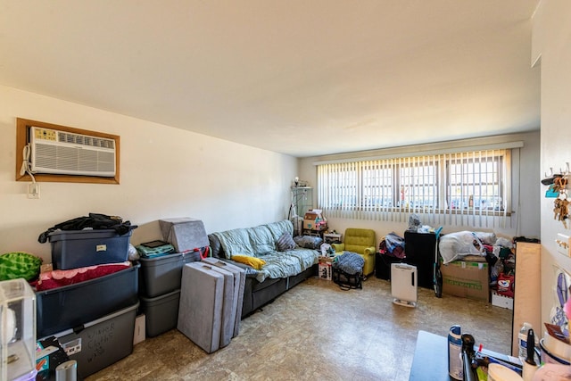 living area featuring a wall unit AC and tile patterned floors