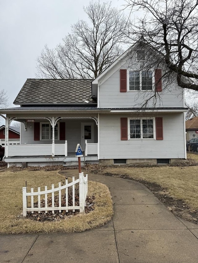 view of front facade with covered porch and a front lawn