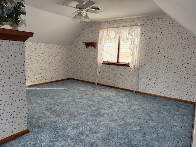 bonus room featuring wallpapered walls, carpet, vaulted ceiling, and a ceiling fan