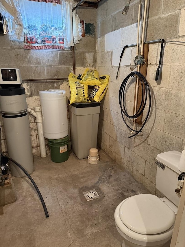 bathroom with toilet and unfinished concrete floors