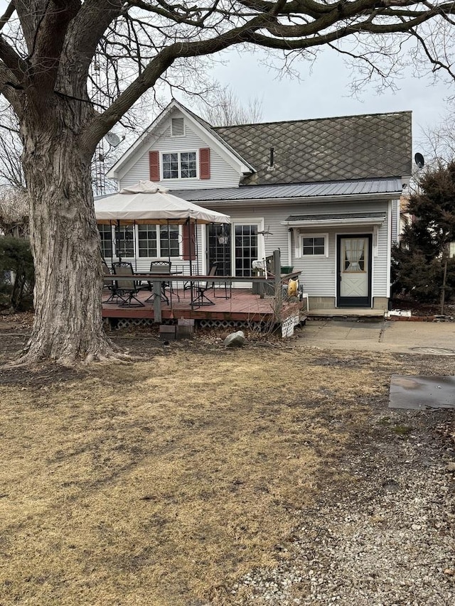 rear view of house featuring a deck