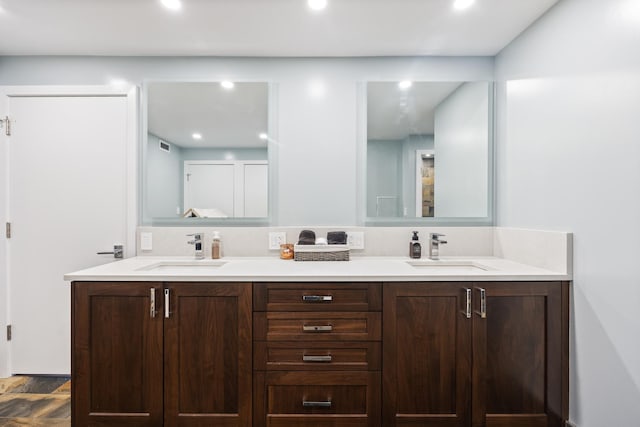 full bathroom with double vanity, a sink, and visible vents