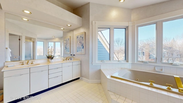 bathroom featuring double vanity, a stall shower, tile patterned floors, a whirlpool tub, and a sink