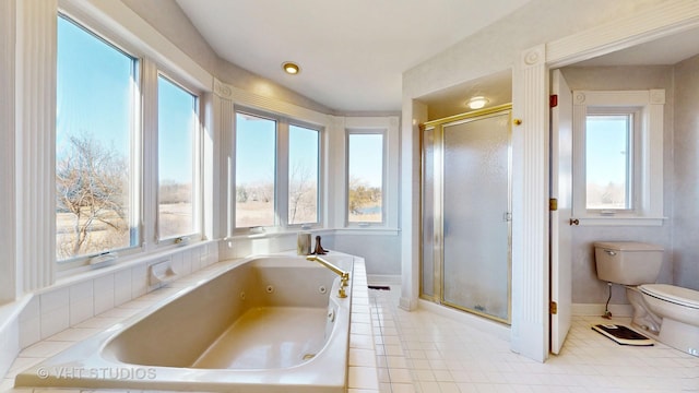 bathroom with a tub with jets, toilet, a shower stall, baseboards, and tile patterned floors