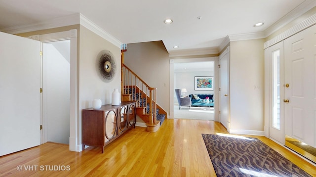 entrance foyer with recessed lighting, crown molding, stairway, and wood finished floors