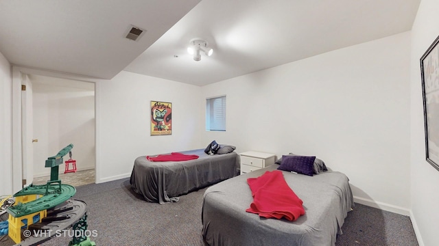 carpeted bedroom with visible vents and baseboards