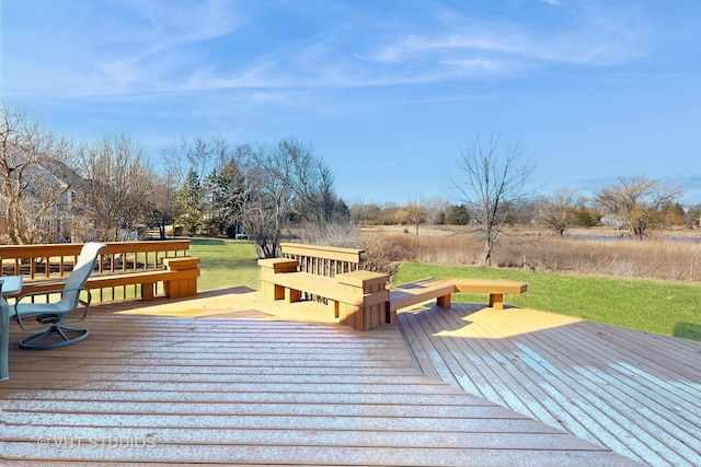 wooden deck featuring a lawn