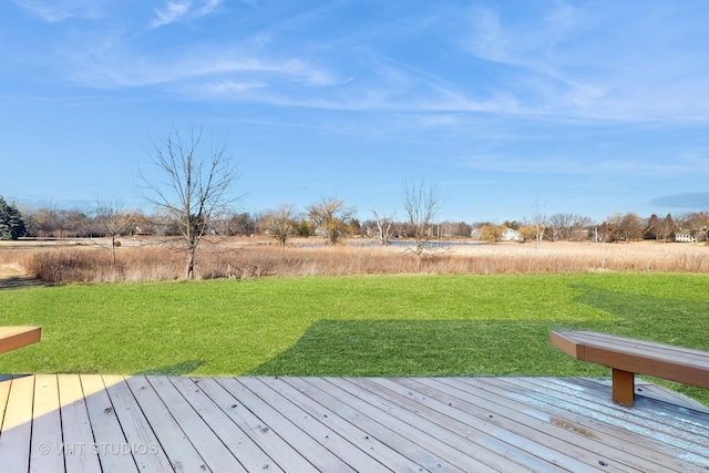 wooden deck featuring a lawn