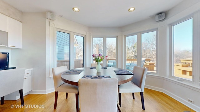 dining space with recessed lighting, baseboards, and light wood finished floors