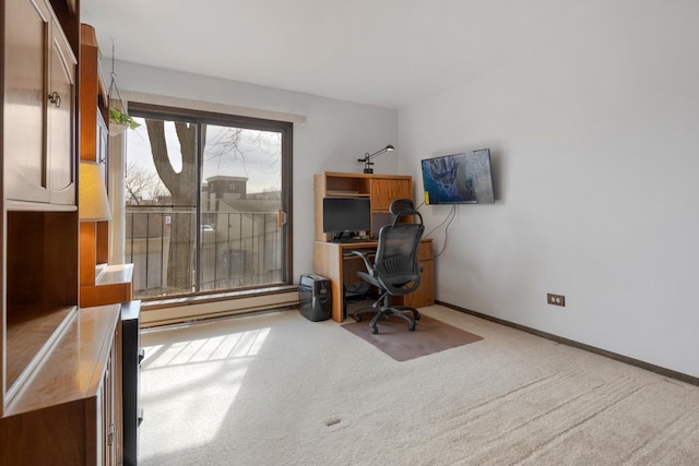 carpeted office space featuring a baseboard radiator and baseboards