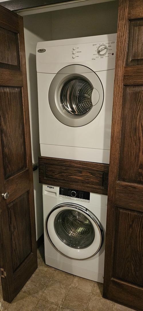 laundry room with laundry area and stacked washer and clothes dryer