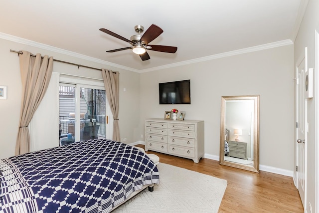 bedroom featuring light wood finished floors, ceiling fan, baseboards, and crown molding