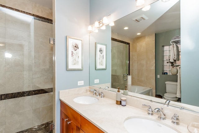 bathroom featuring visible vents, a sink, toilet, and double vanity