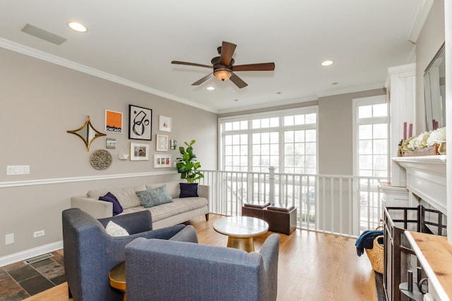 living area with recessed lighting, dark wood finished floors, visible vents, and crown molding