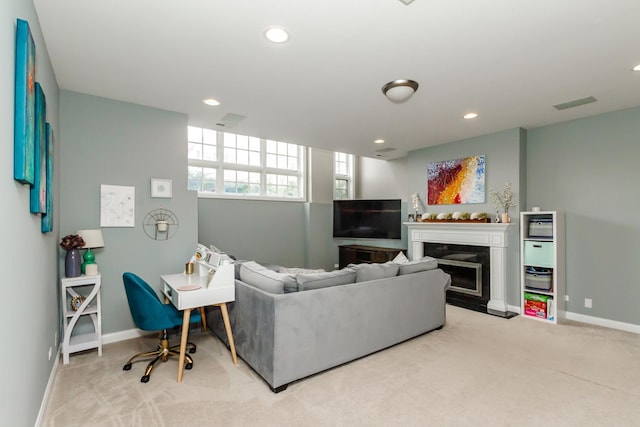 living room featuring recessed lighting, light colored carpet, a fireplace, and baseboards