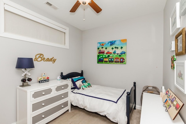 carpeted bedroom with ceiling fan and visible vents