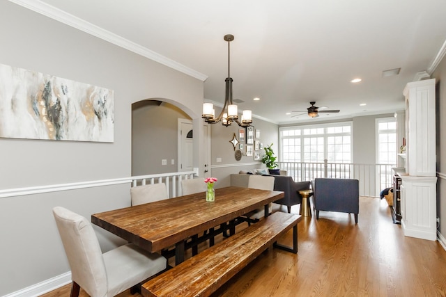 dining area with ornamental molding, light wood-style flooring, and recessed lighting