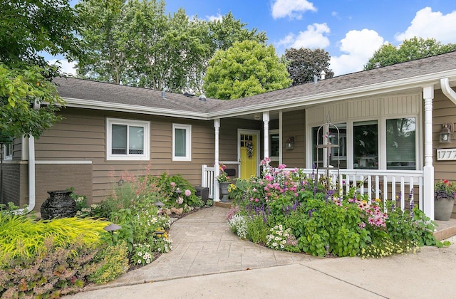 view of front of house featuring brick siding and covered porch