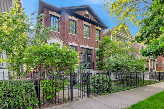 view of front of house with a fenced front yard and brick siding