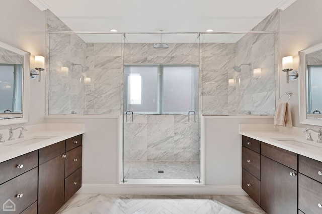 bathroom featuring marble finish floor, two vanities, a sink, and a stall shower