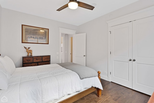 bedroom with a ceiling fan, a closet, dark wood finished floors, and baseboards