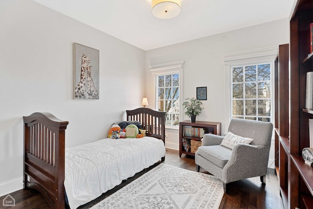 bedroom with dark wood-style floors and baseboards