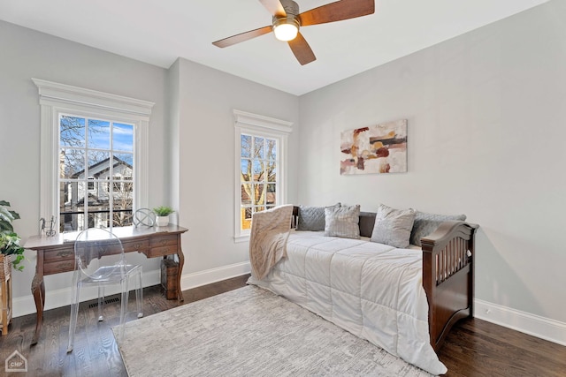 bedroom featuring ceiling fan, baseboards, and wood finished floors