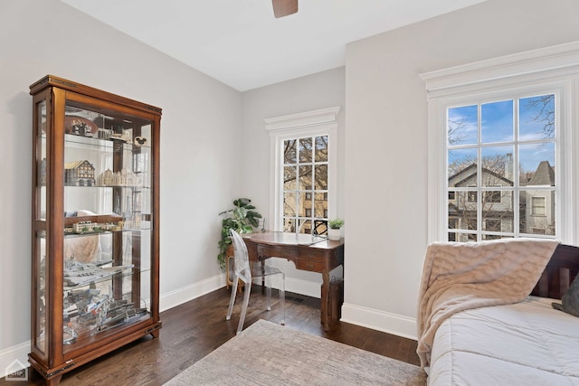 interior space featuring baseboards and wood finished floors