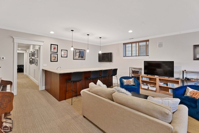 living area with recessed lighting, light carpet, baseboards, wet bar, and crown molding