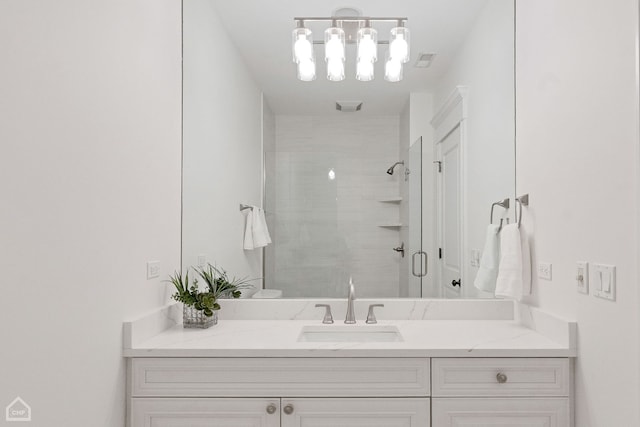 bathroom with a shower stall and vanity