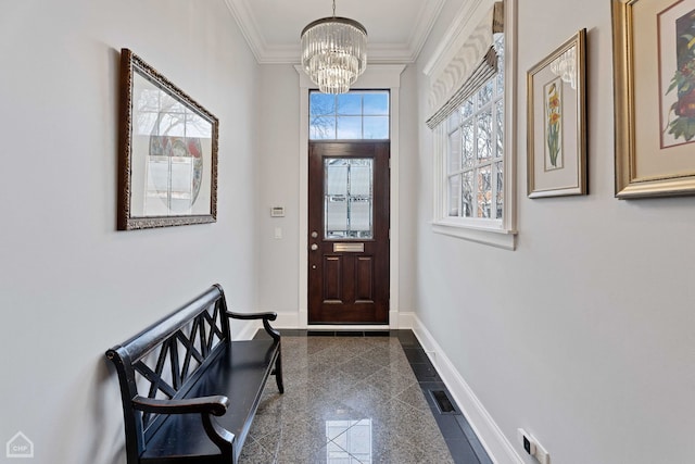 foyer featuring a notable chandelier, ornamental molding, granite finish floor, and baseboards