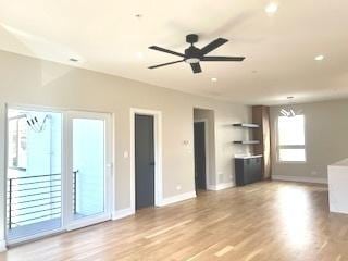 unfurnished living room featuring ceiling fan, light wood finished floors, recessed lighting, and baseboards