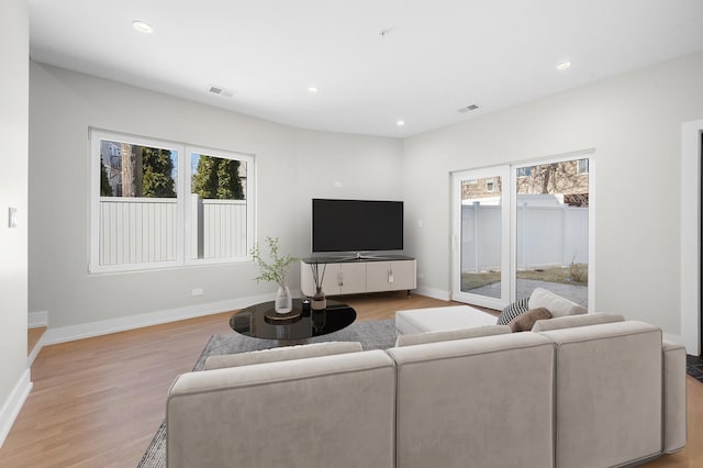 living area with a wealth of natural light, recessed lighting, and light wood-type flooring