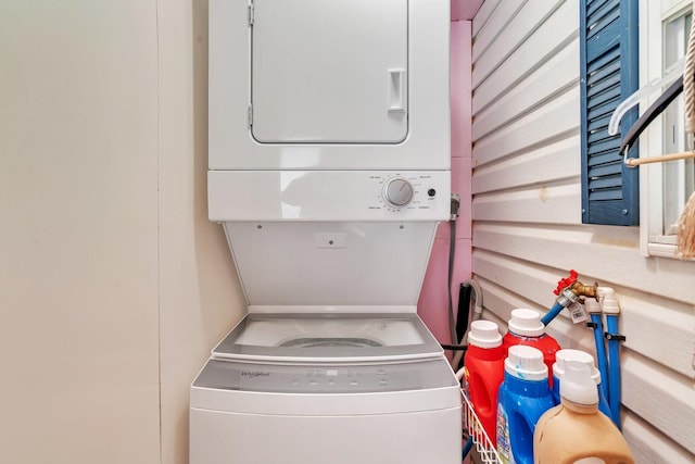 clothes washing area with laundry area and stacked washer / dryer