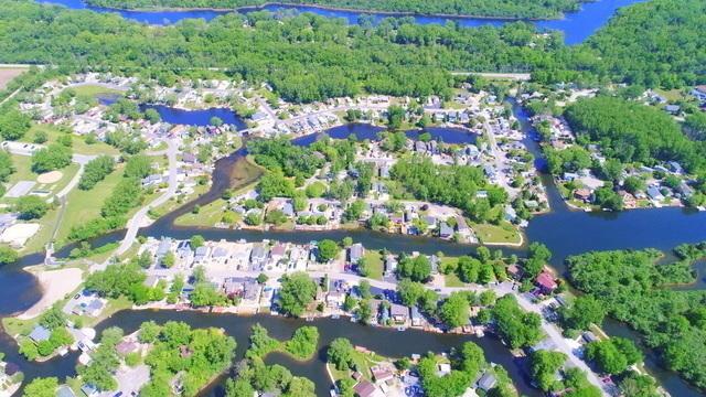 aerial view with a water view and a wooded view