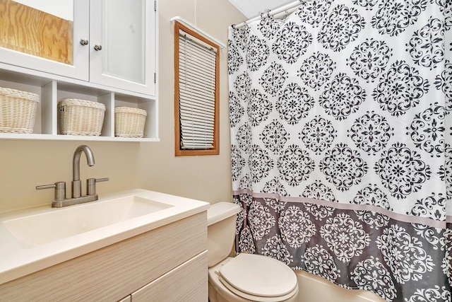 full bathroom featuring toilet and vanity