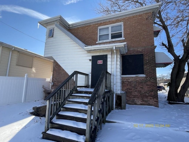 view of front of property with fence and brick siding