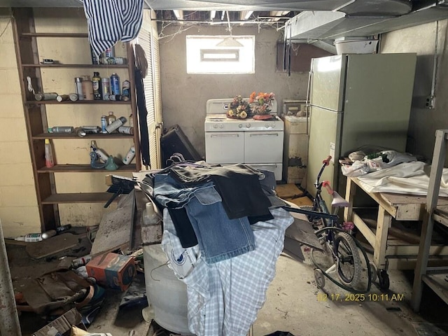 interior space featuring range with two ovens, freestanding refrigerator, and concrete flooring