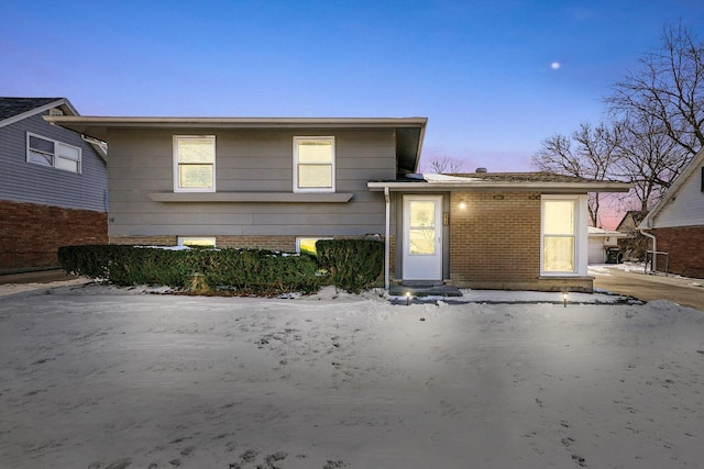 split level home featuring brick siding